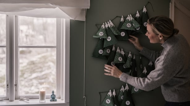 Woman with christmas calendar with gifts