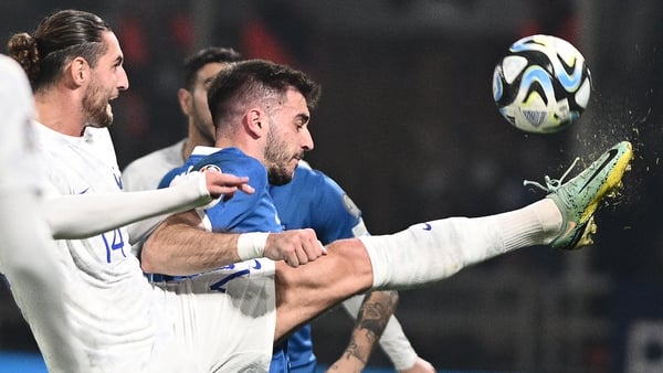 Greek goalscorer Fotis Ioannidis (R) fights for the ball with France midfielder Adrien Rabiot